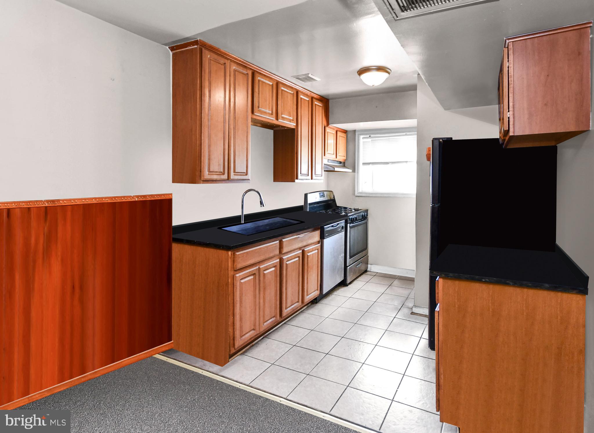 5009 D Street Southeast, Unit 202 Washington, DC 20019 - Photo 5 of 12 a kitchen with stainless steel appliances a sink stove and refrigerator