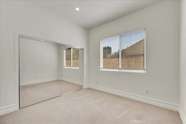 a bathroom with a granite countertop bathtub sink vanity mirror and toilet