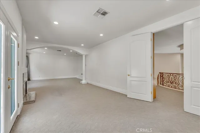 a view of an empty room with a fireplace and a large window