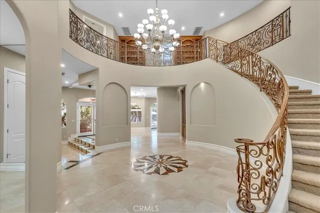 a view of a lobby with furniture and chandelier