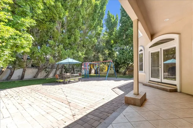 a view of a house with a yard and sitting area