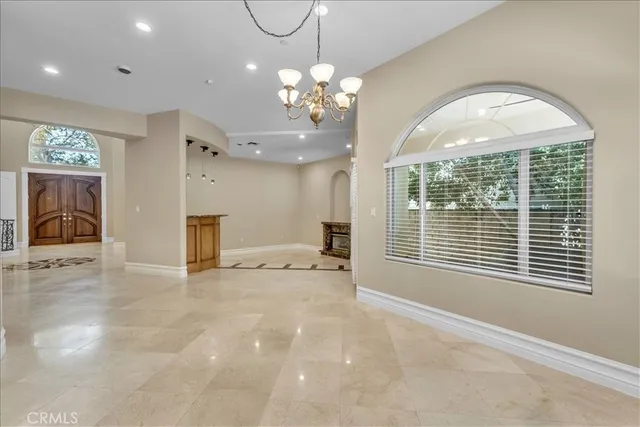 a dining room with stainless steel appliances kitchen island granite countertop a sink a stove a dining table and chairs