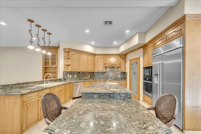 a kitchen with granite countertop a sink and cabinets
