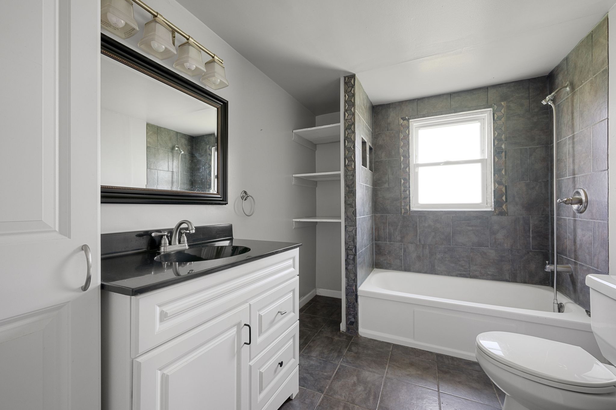 227 Pleasant View Road White Bluff, TN 37187 - Photo 12 of 19 a bathroom with a bathtub sink vanity mirror and toilet