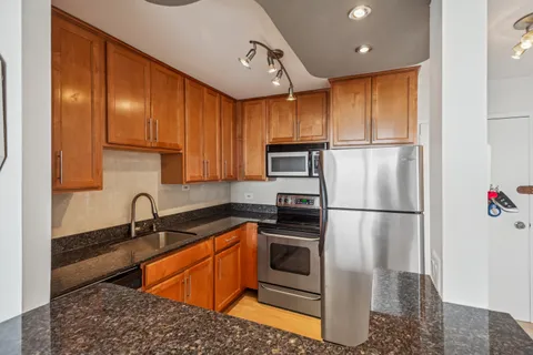a view of kitchen with cabinets and wooden floor