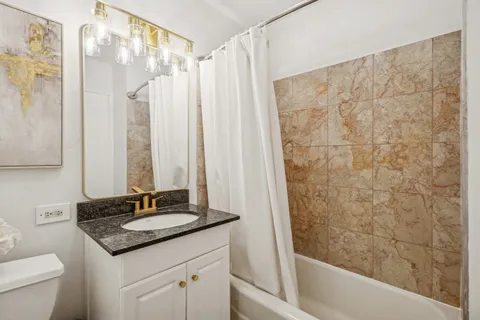 a bathroom with a sink toilet and mirror