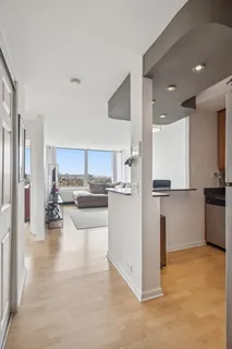 a kitchen with stainless steel appliances granite countertop a sink refrigerator and cabinets