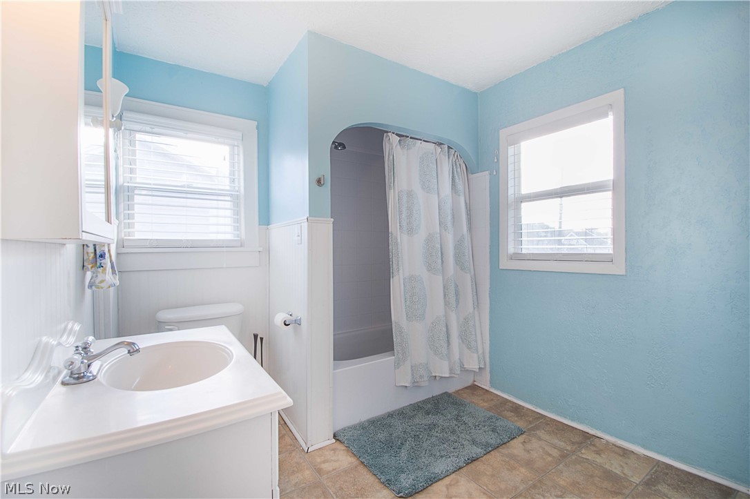 2306 10th Street Northwest Canton, OH 44708 - Photo 14 of 23 Upstairs you will find a full bathroom with wainscotting walls, shower/tub combo, built-in drawers, and shelves.
