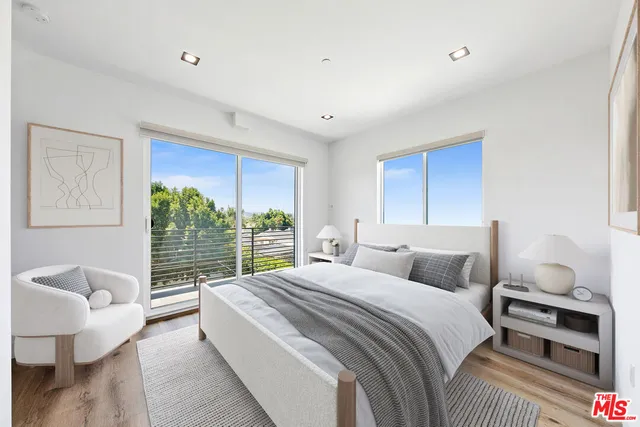 a bedroom with a large bed and a couch