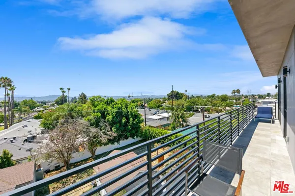 a view of a balcony with wooden floor