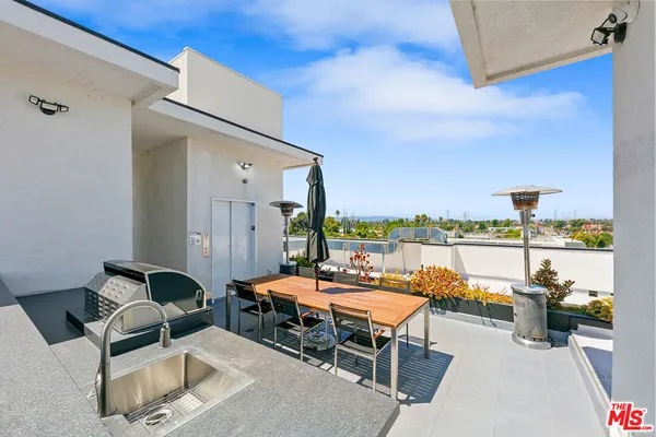 a terrace with outdoor seating and city view