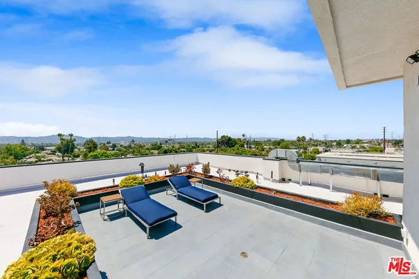 a view of swimming pool with outdoor seating and city view