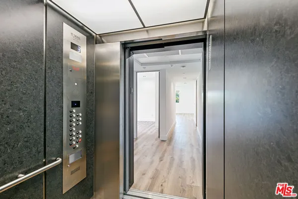 a bathroom with a glass shower door and mirror
