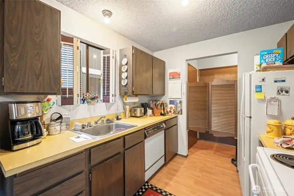 a kitchen with a sink stove and refrigerator