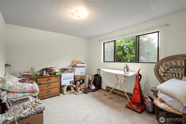 a bedroom with furniture and a large window