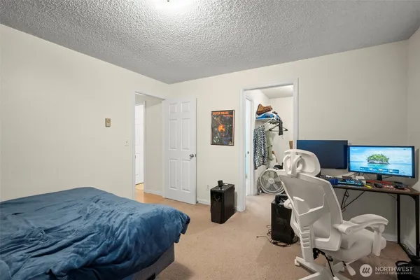 a bedroom with bed and a chandelier