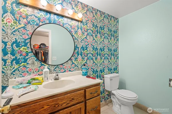 a bathroom with a sink mirror vanity and toilet