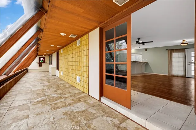 a view of a living room a kitchen island wooden floor and furniture