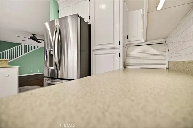 a spacious bathroom with a granite countertop sink and a mirror