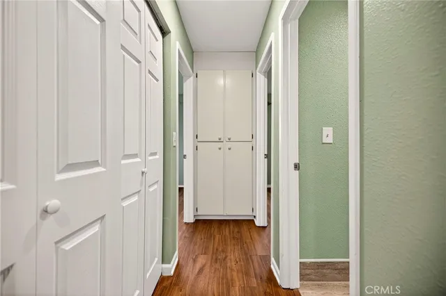 a view of room with window ceiling fan and hardwood floor