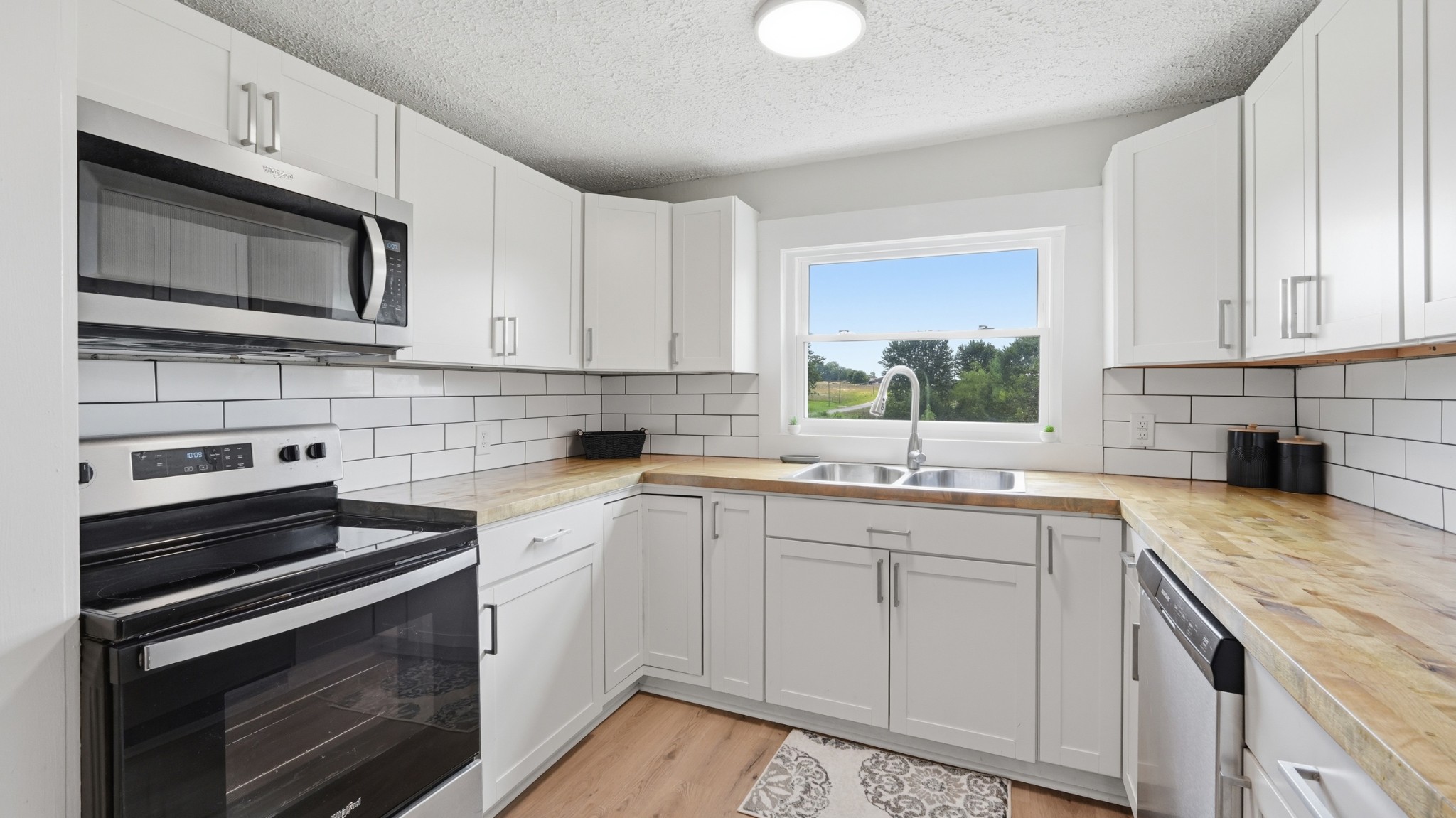 469 Fred Cooper Road McMinnville, TN 37110 - Photo 14 of 46 a kitchen with a sink stove and microwave