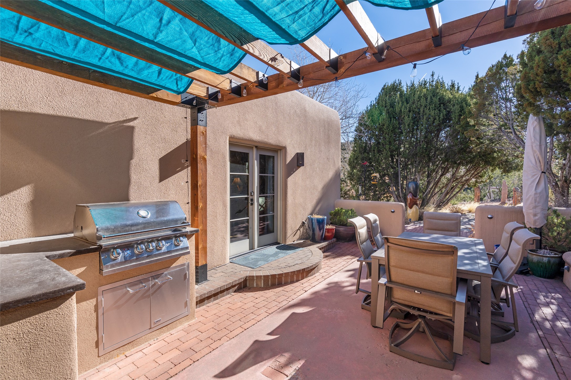 1204 Bandolina Road Santa Fe, NM 87501 - Photo 26 of 69 Back patio with built-in grill; French doors to primary suite