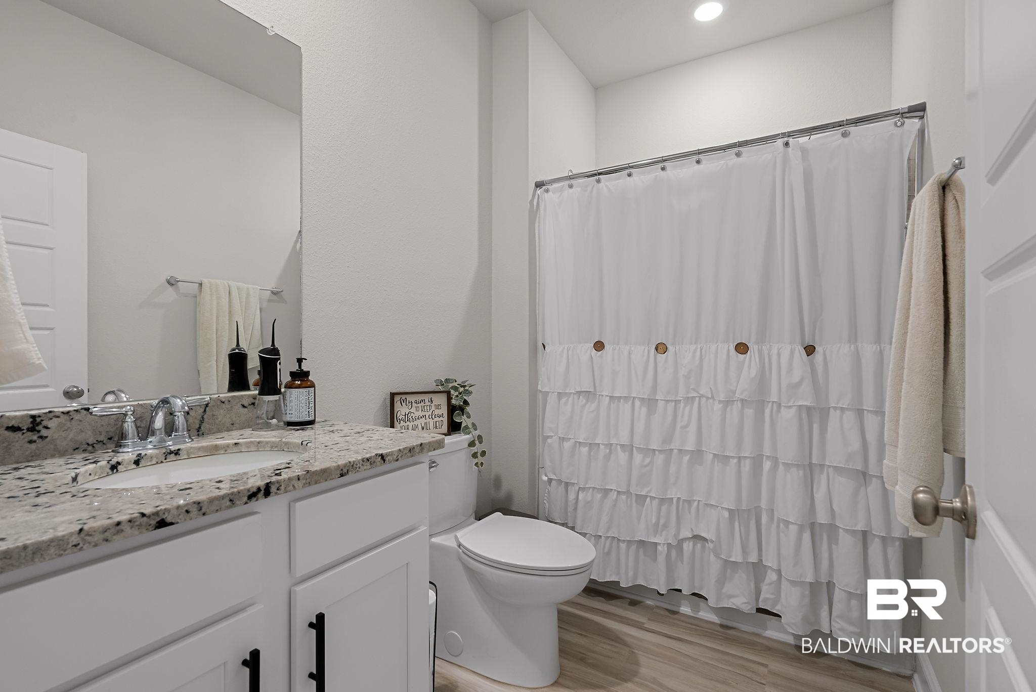 13966 Antler Hl Road Daphne, AL 36527 - Photo 24 of 44 Bathroom featuring a single vanity with stone countertop, undermount sink, and chrome faucet