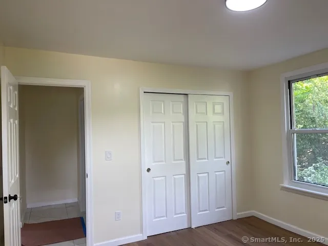 an empty room with windows and closet