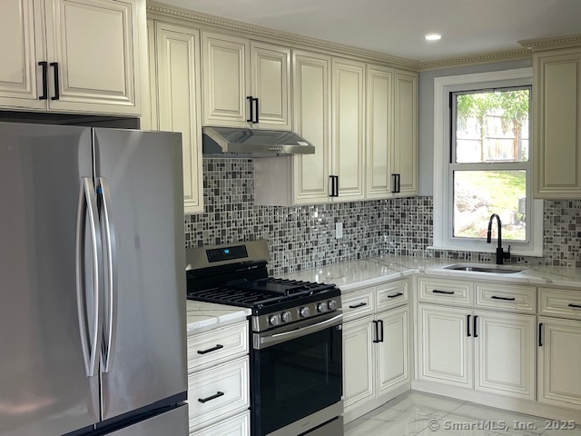 280 Meriden Road Waterbury, CT 06705 - Photo 2 of 27 a kitchen with appliances a sink and a window