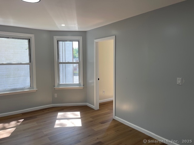 280 Meriden Road Waterbury, CT 06705 - Photo 24 of 27 an empty room with wooden floor and windows