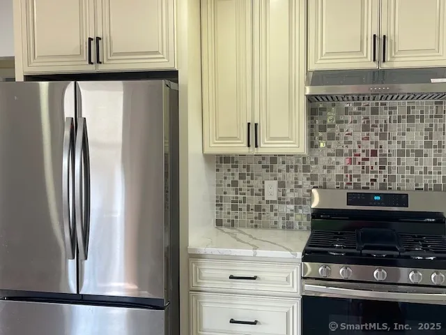 a close view of a stove top oven and cabinets