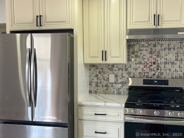 280 Meriden Road Waterbury, CT 06705 - Photo 4 of 27 a close view of a stove top oven and cabinets