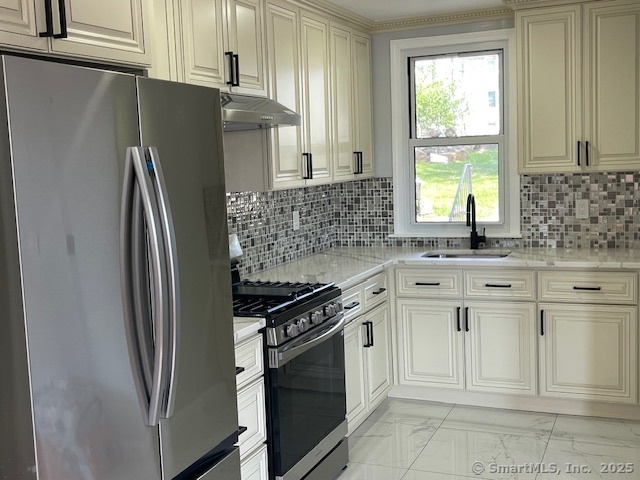 280 Meriden Road Waterbury, CT 06705 - Photo 5 of 27 a kitchen with white cabinets and a refrigerator