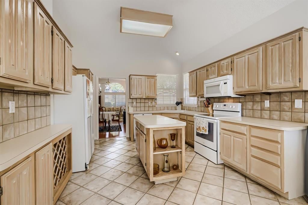 1413 West Peters Colony Road Carrollton, TX 75007 - Photo 12 of 29 a kitchen with white cabinets appliances and a window