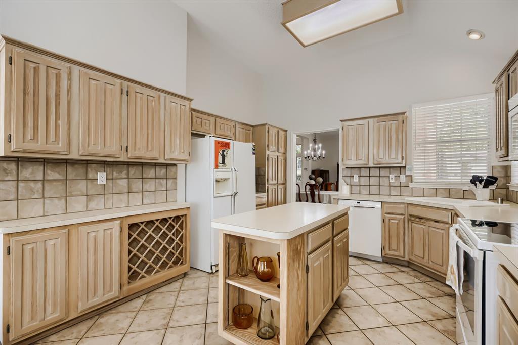 1413 West Peters Colony Road Carrollton, TX 75007 - Photo 13 of 29 a kitchen that has a lot of white cabinets