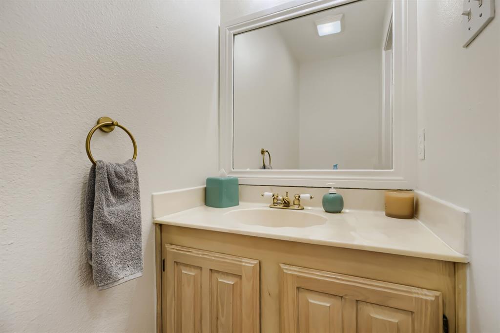 1413 West Peters Colony Road Carrollton, TX 75007 - Photo 15 of 29 a bathroom with a sink and a mirror