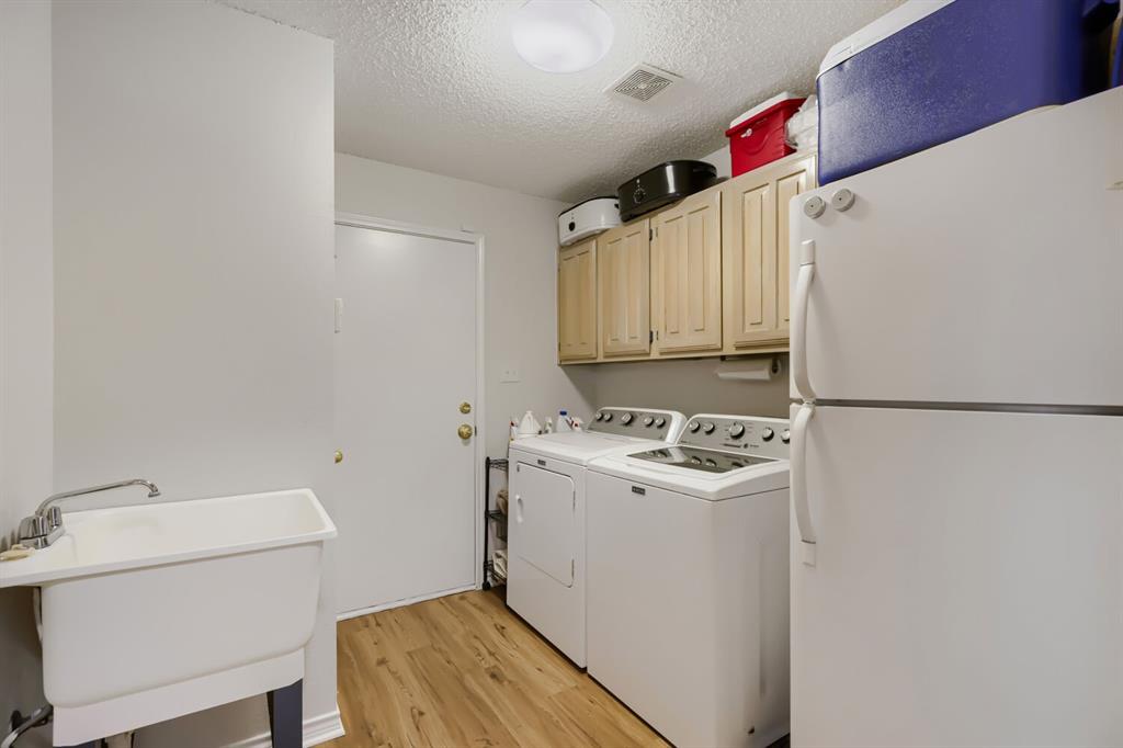 1413 West Peters Colony Road Carrollton, TX 75007 - Photo 16 of 29 a kitchen with a stove and a refrigerator