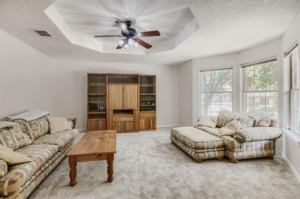 1413 West Peters Colony Road Carrollton, TX 75007 - Photo 21 of 29 a bedroom with a bed and ceiling fan