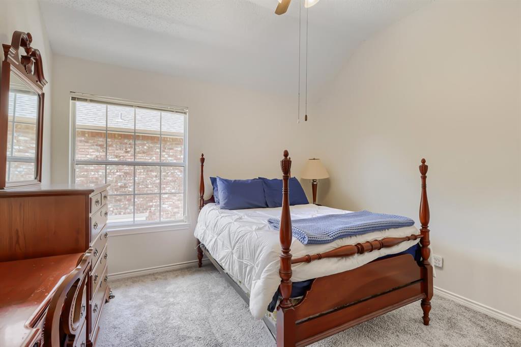 1413 West Peters Colony Road Carrollton, TX 75007 - Photo 22 of 29 a bedroom with a bed and a window