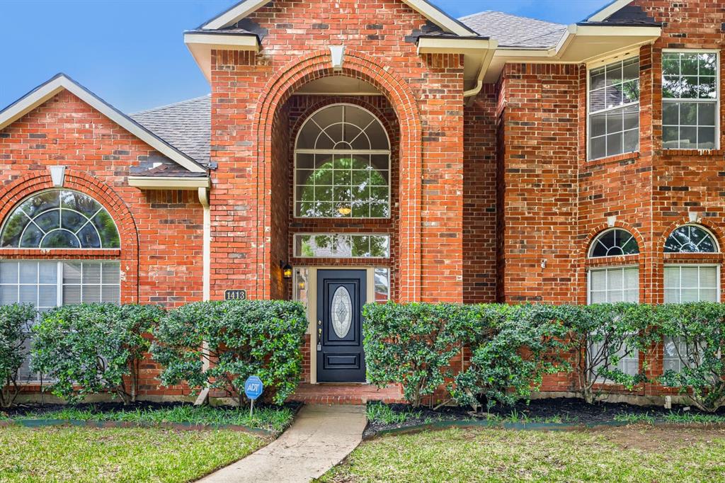 1413 West Peters Colony Road Carrollton, TX 75007 - Photo 3 of 29 a front view of a house with garden