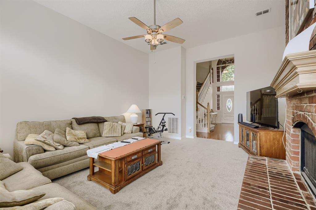1413 West Peters Colony Road Carrollton, TX 75007 - Photo 10 of 29 a living room with furniture a flat screen tv and a fireplace