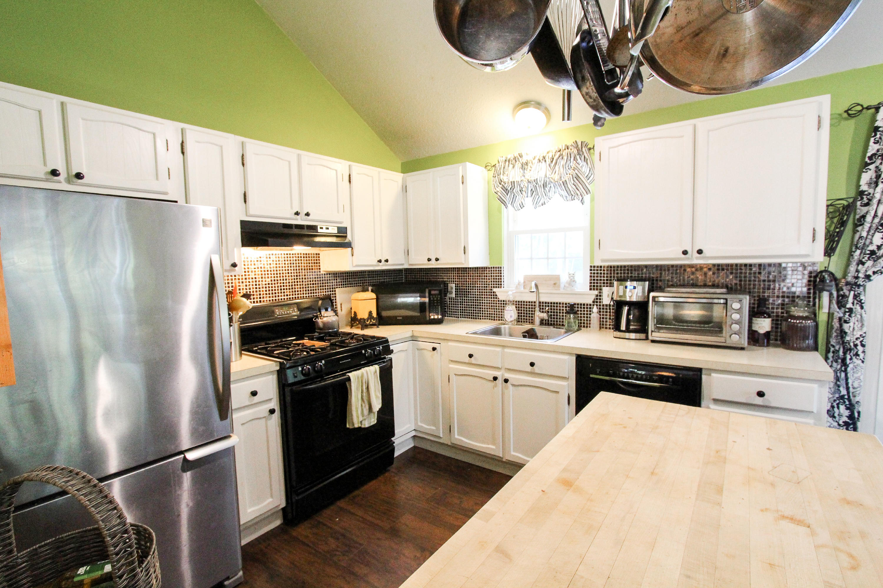50 Ensign Road Centerville, MA 02632 - Photo 4 of 21 a kitchen with stainless steel appliances granite countertop a stove a refrigerator and a sink with wooden floor