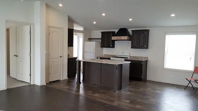 a kitchen with a sink cabinets and a window