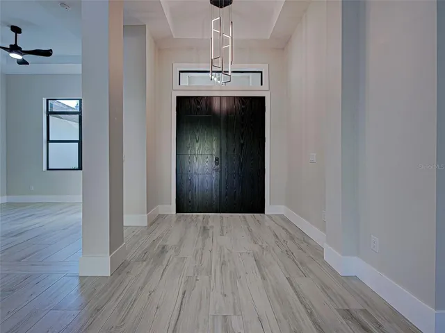 a large kitchen with stainless steel appliances granite countertop a large counter top and wooden floors