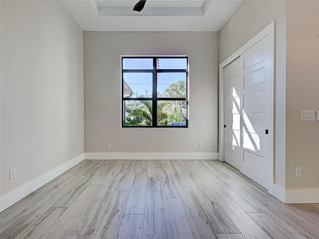 a large kitchen with cabinets wooden floor and stainless steel appliances
