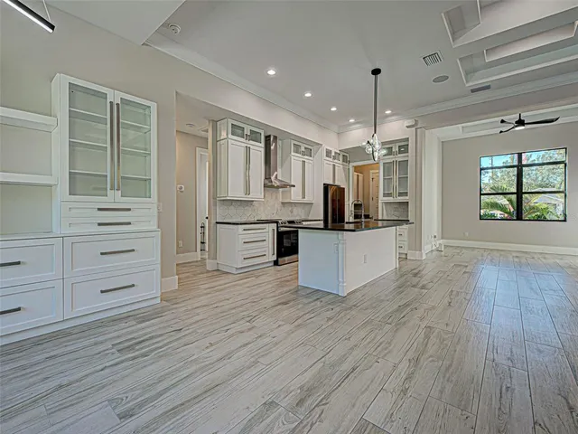 a large kitchen with stainless steel appliances granite countertop a stove and a sink