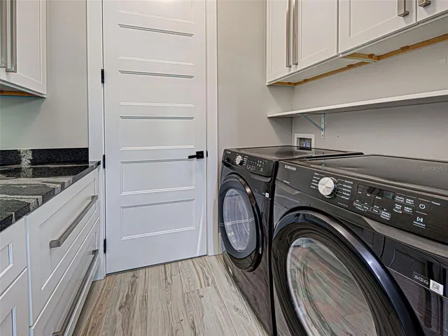 a view of a livingroom with an empty space & wooden floor