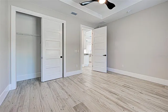 a bathroom with a granite countertop sink toilet and mirror