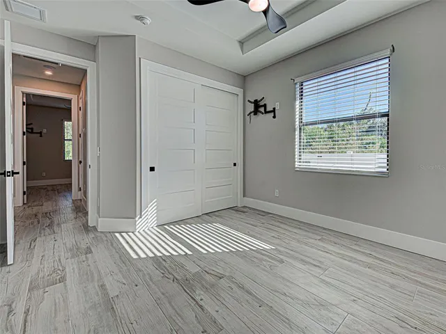 a spacious bathroom with a granite countertop sink mirror and bathtub
