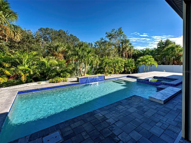 a view of a backyard with sitting area